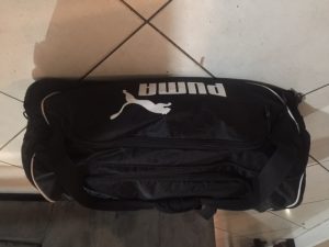 PUMA 36 inch duffle bag closed with all cleaning supplies